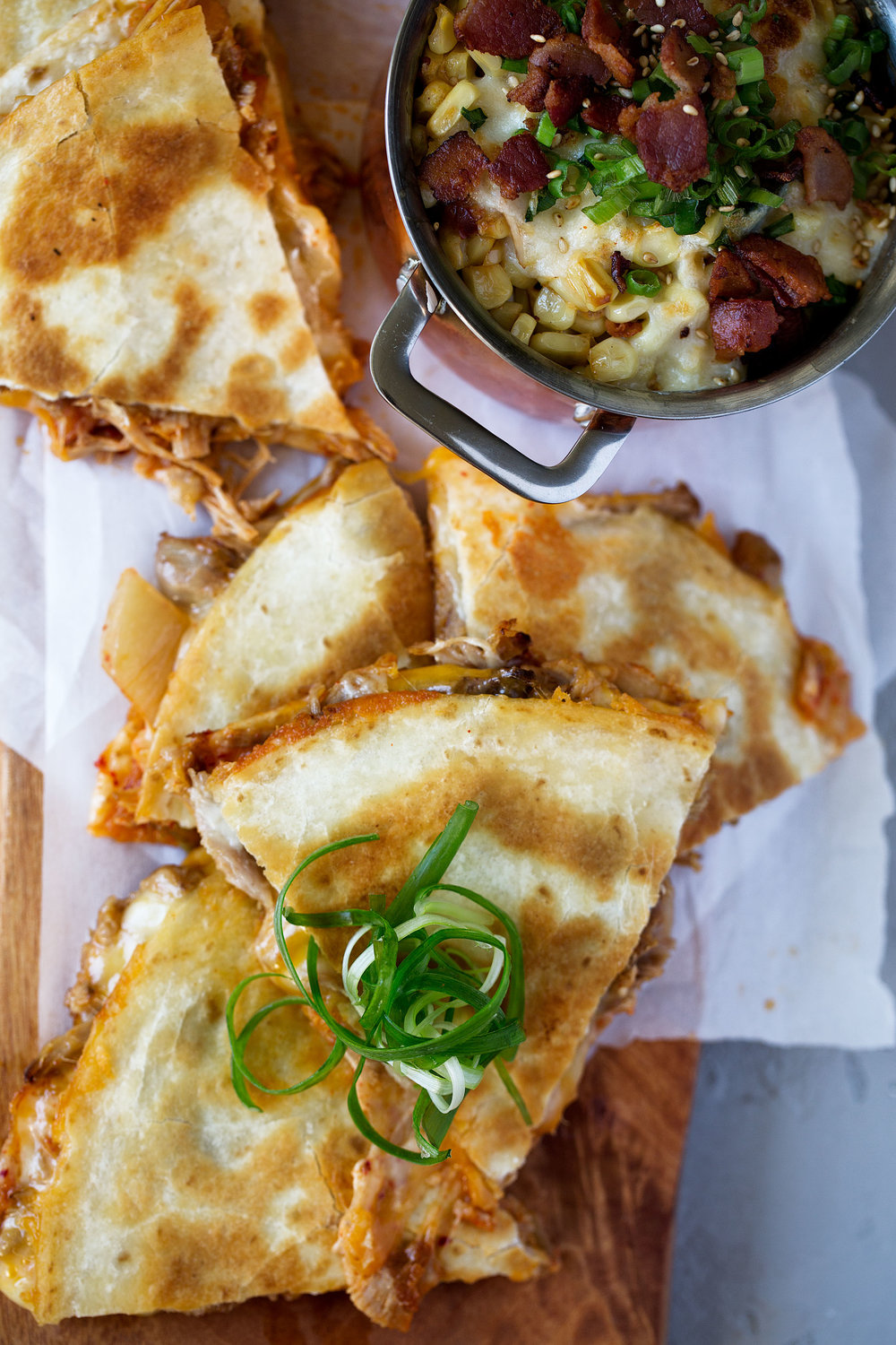 korean braised pork and kimchi quesadilla topped with scallions