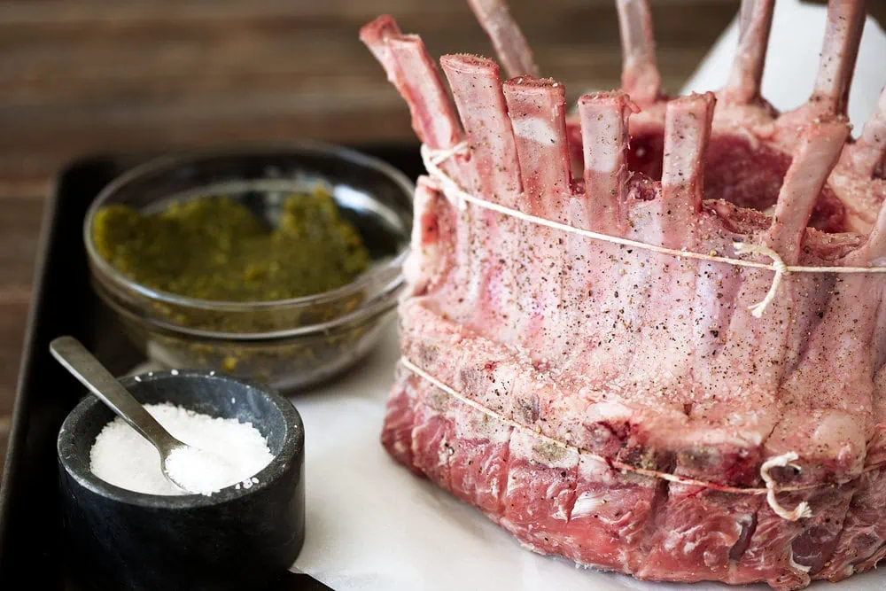 Pistachio Crusted Crown of lamb with Pomegranate Glaze applying rub