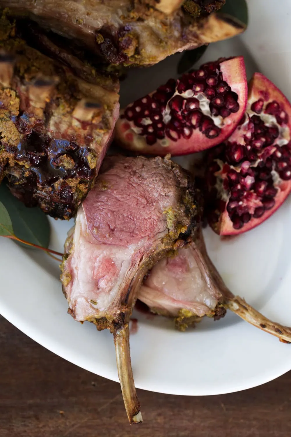 cut Pistachio Crusted Crown of lamb with Pomegranate Glaze cooking with cocktail rings