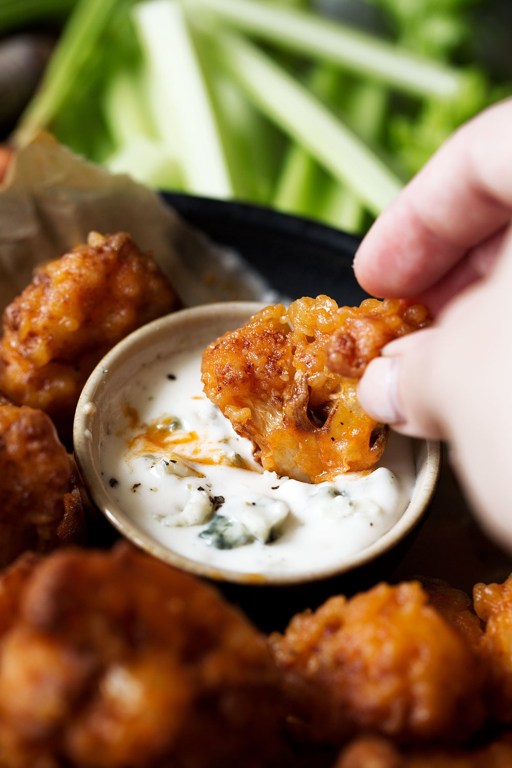 Crispy battered and fried cauliflower bites tossed in homemade buffalo sauce are a great vegetarian alternative to buffalo chicken wings