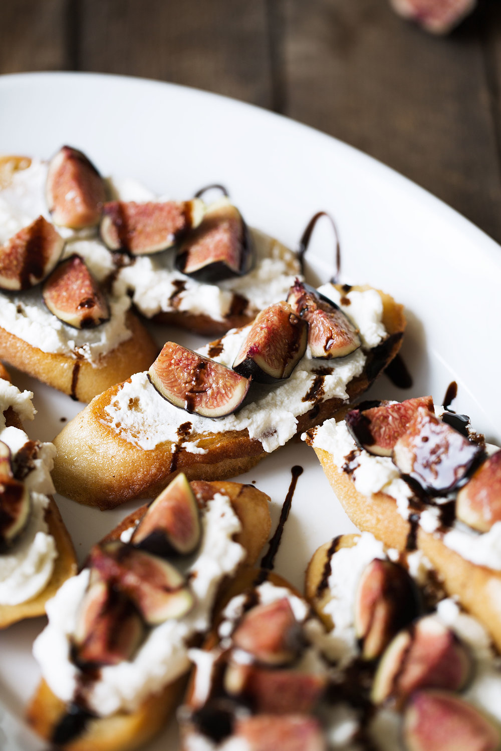 crostini with ricotta, figs and balsamic cooking with cocktail rings closeup side view