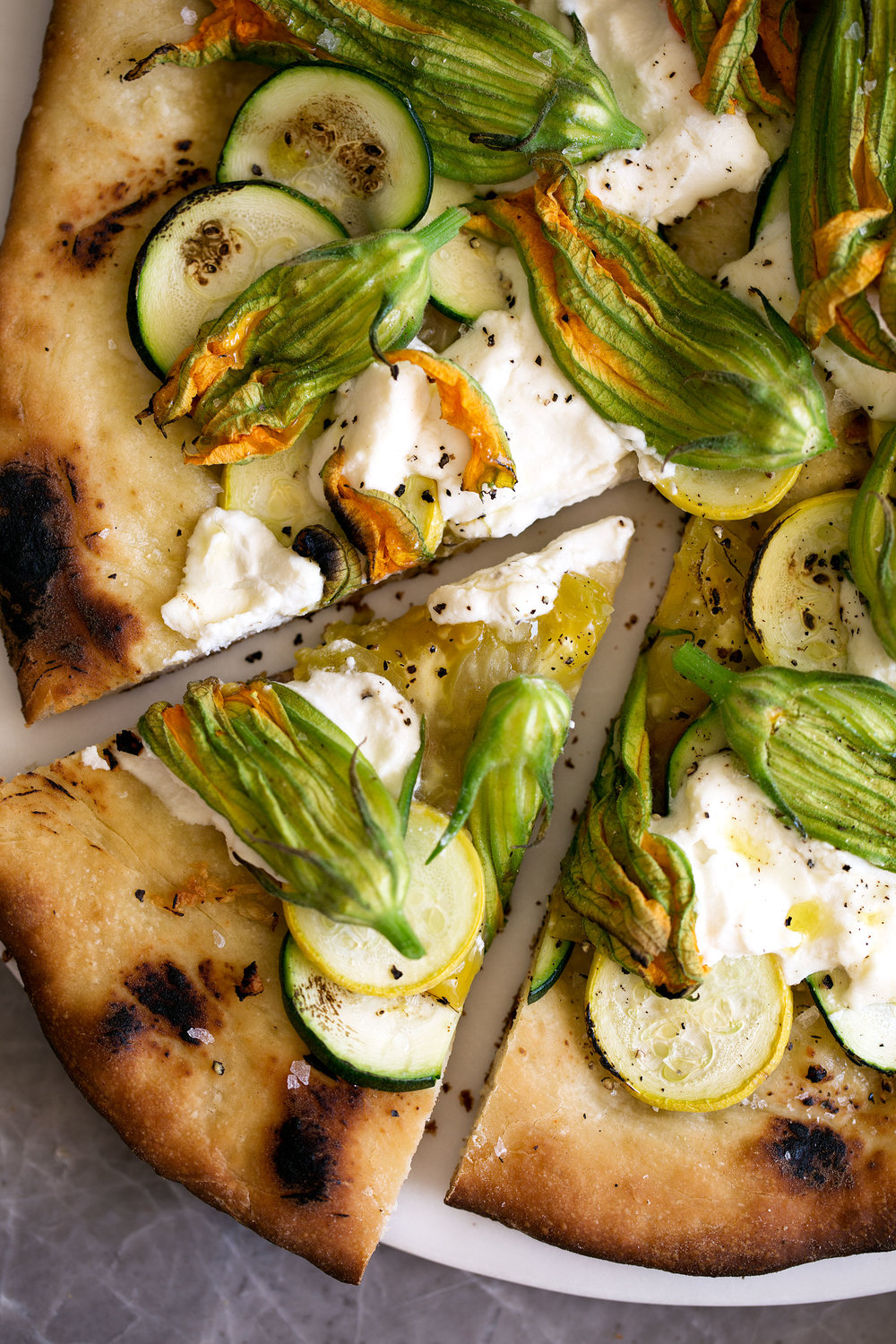 squash blossom and ricotta pizza with zucchini heirloom tomato cooking with cocktail rings slice