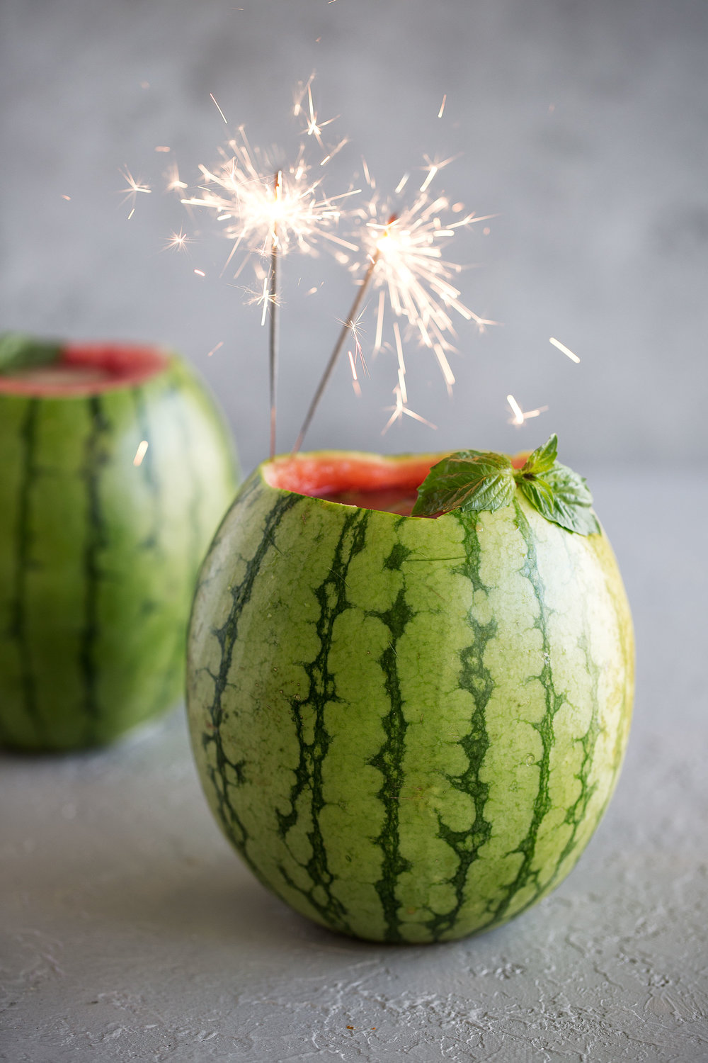 watermelon basil gimlet bucket with herbs and sparklers 