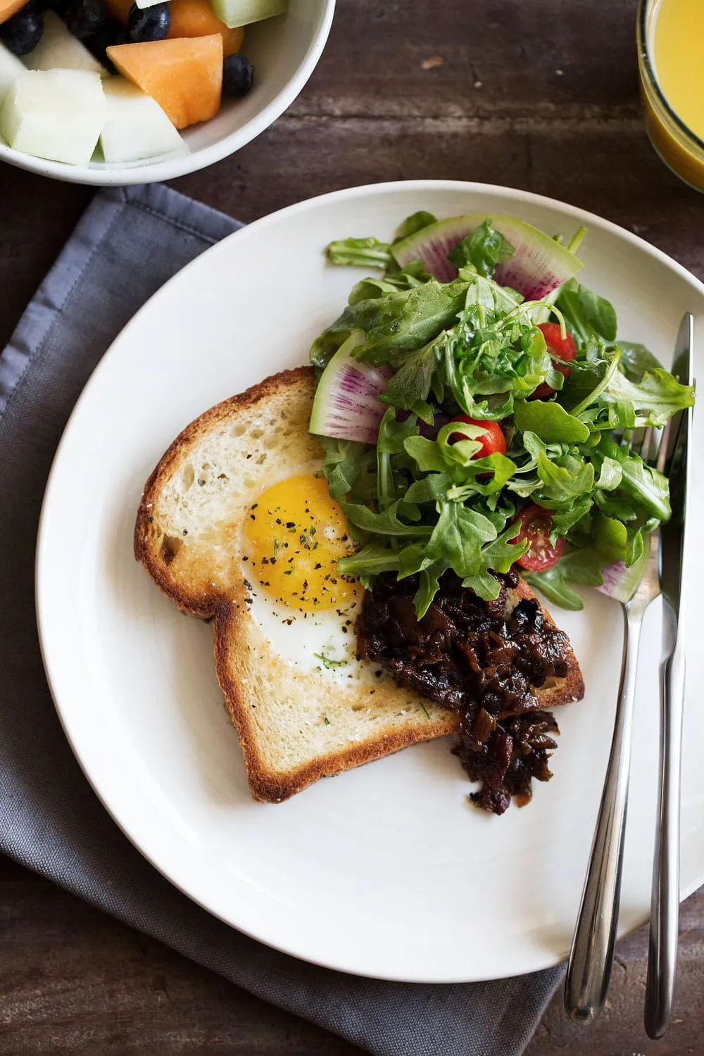 egg in a hole brioche toast with bacon onion jam cooking with cocktail rings