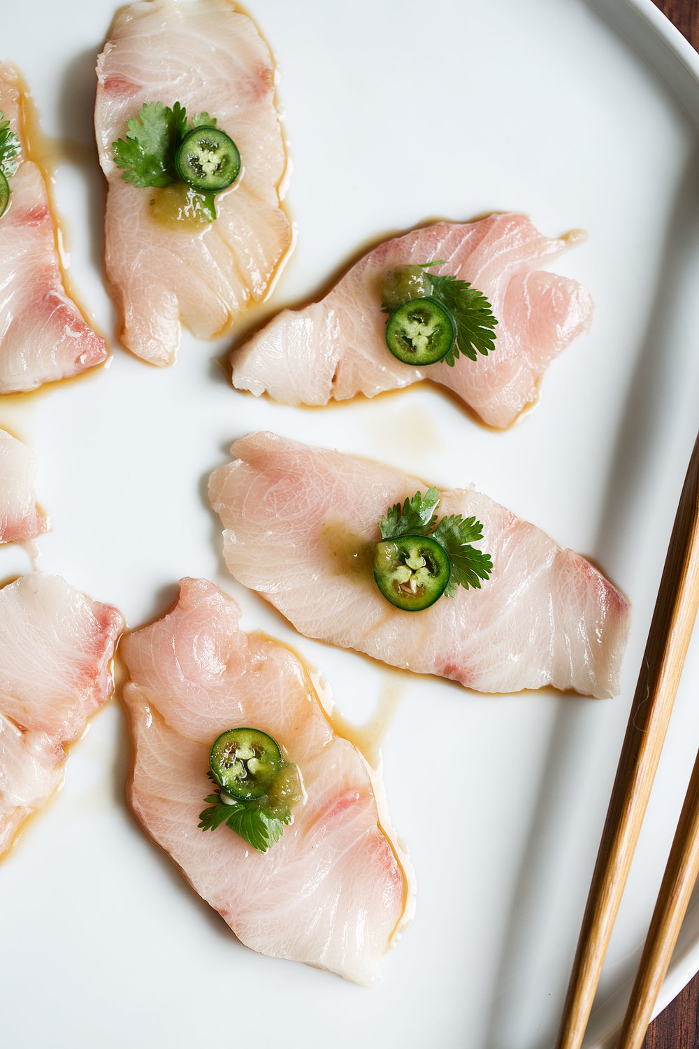 yellowtail sashimi with serrano and ponzu closeup