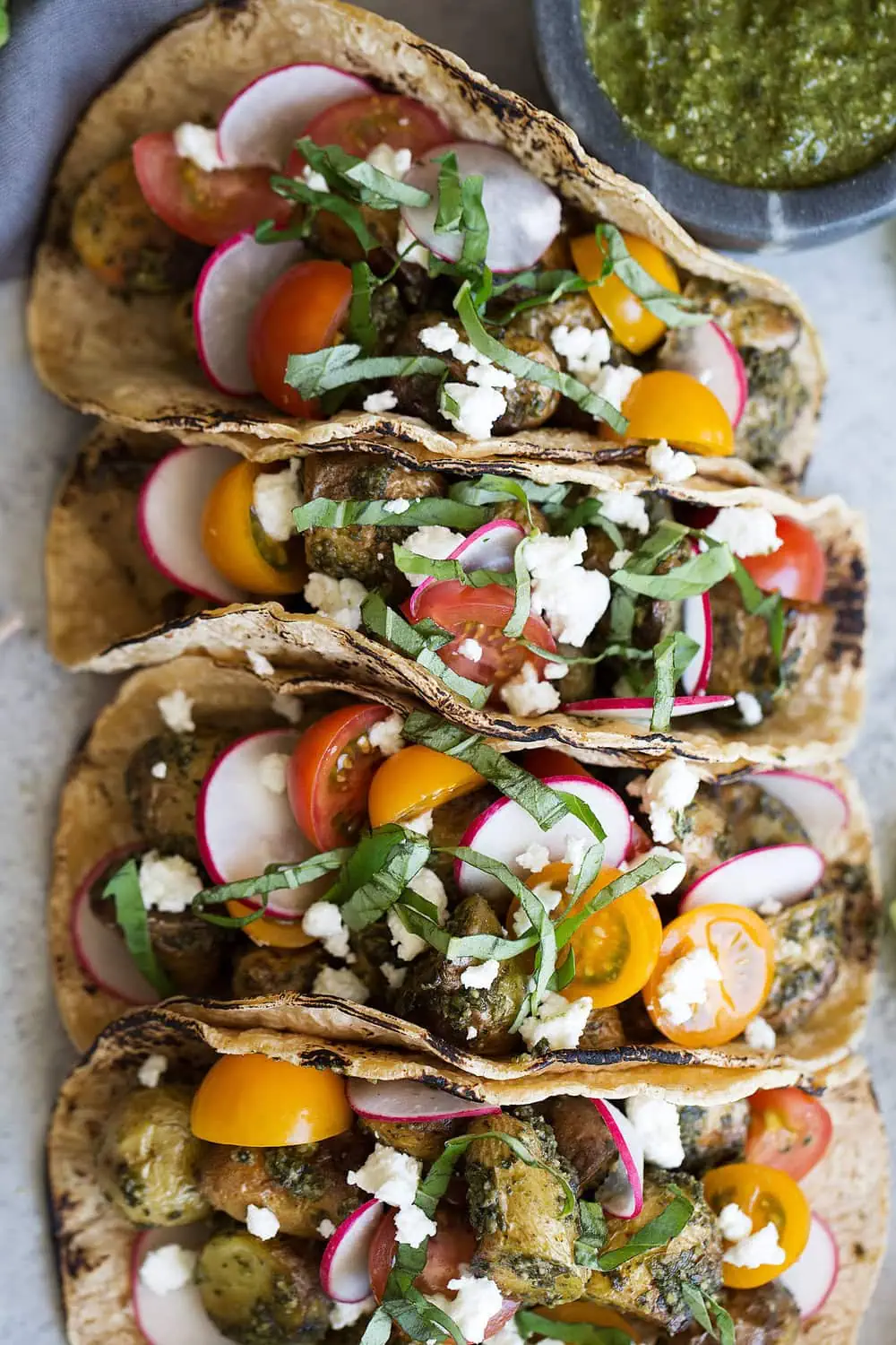 pesto potato tacos with goat cheese and cherry tomatoes