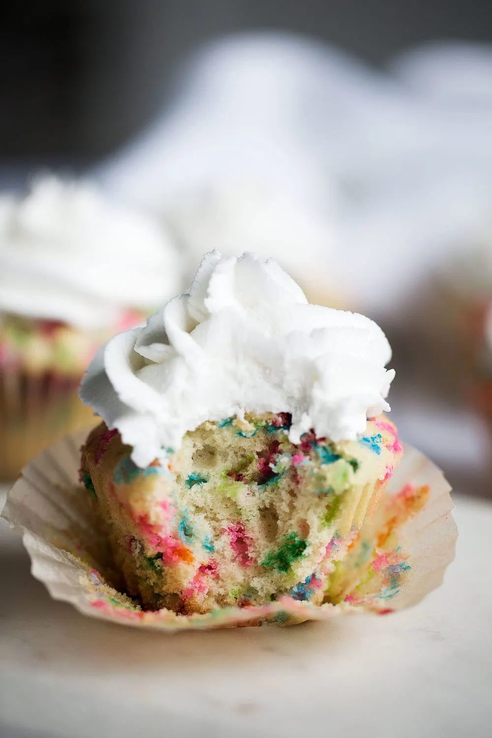 cereal milk funfetti cupcakes with bite taken out