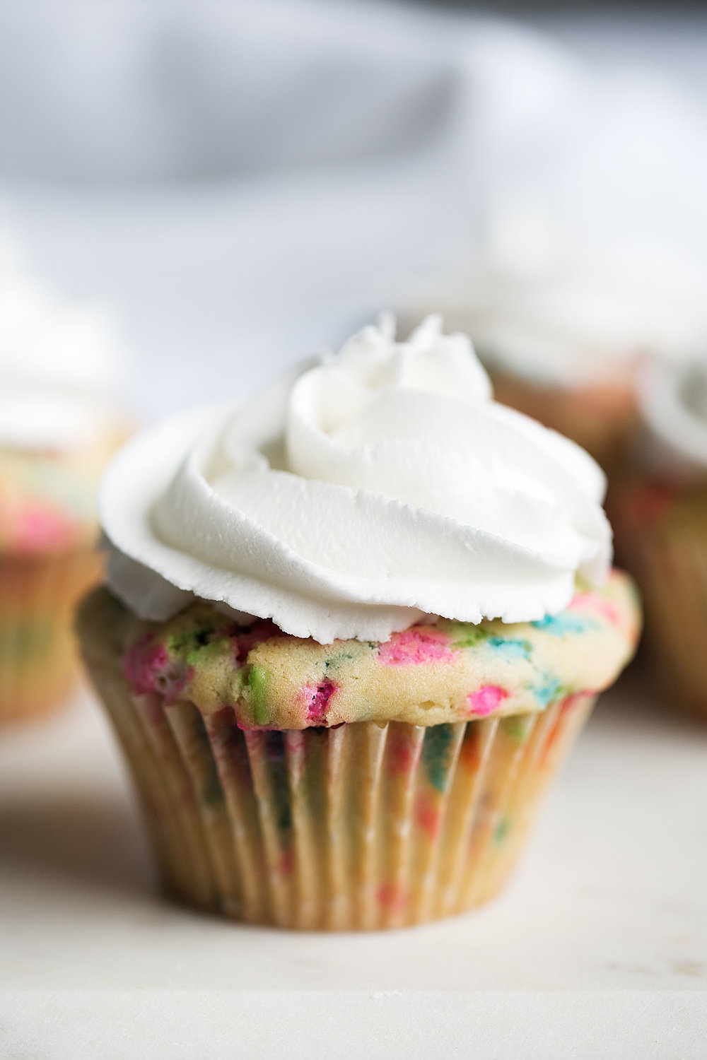 cereal milk funfetti cupcake with vanilla frosting