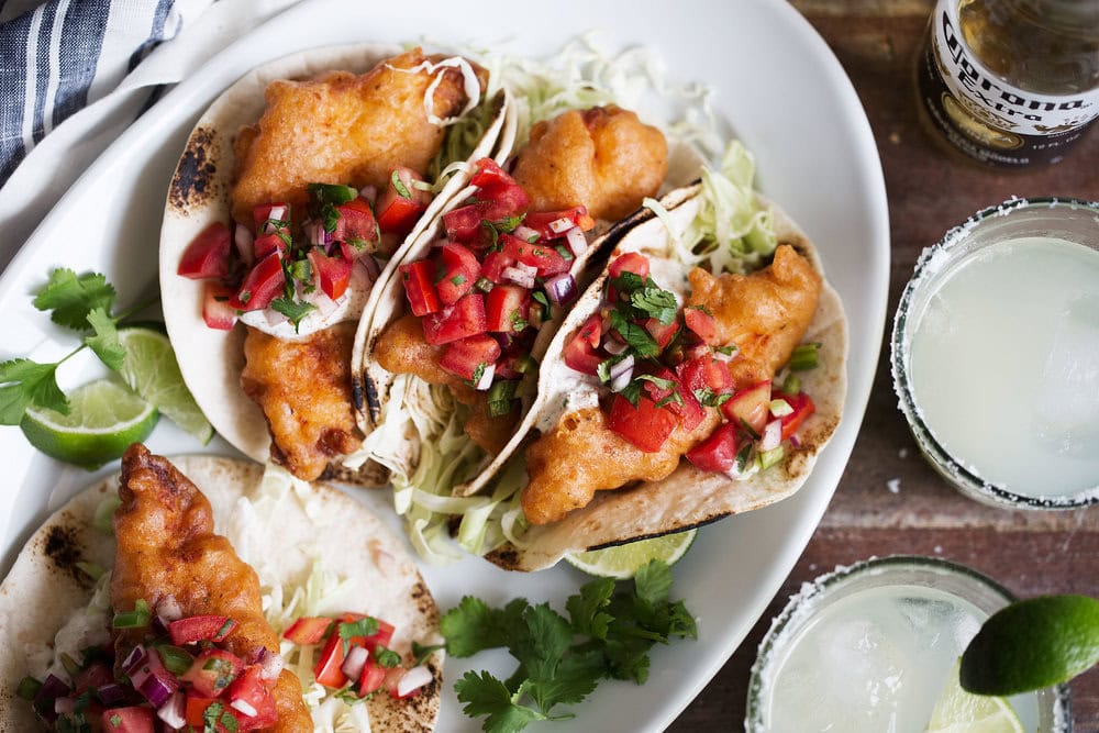 beer battered baja fish tacos with herb yogurt sauce with cornona and margaritas