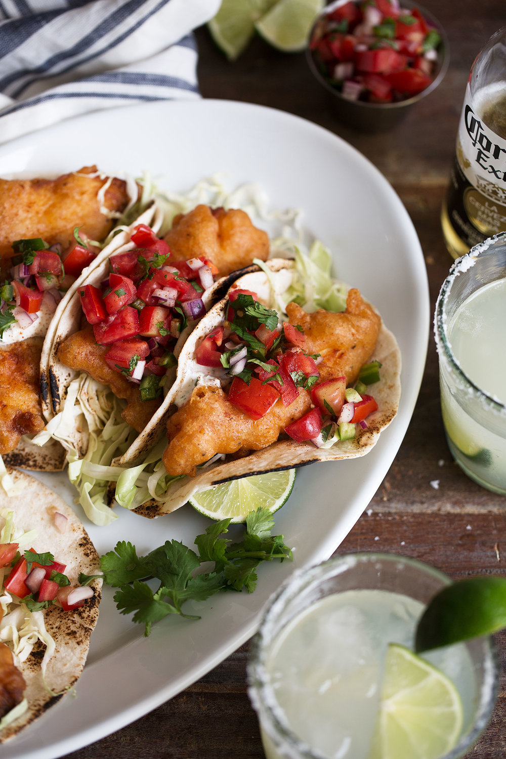 closeup beer battered baja fish tacos with herb yogurt sauce