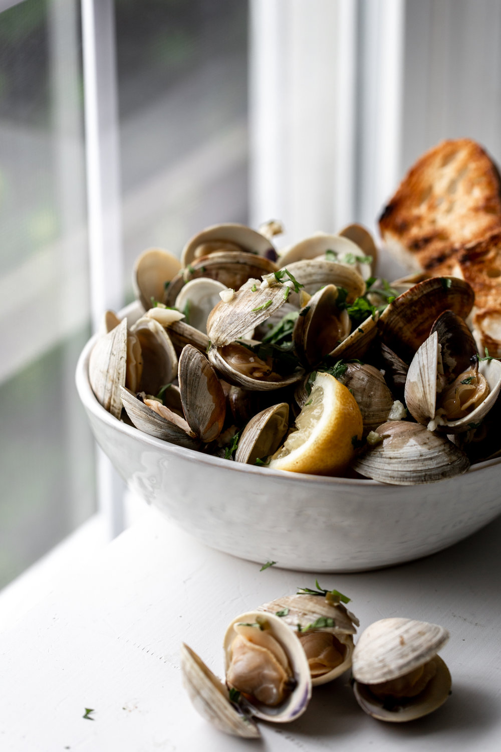 Clams in White Wine Sauce with Serrano Garlic Butter and grilled bread with lemons