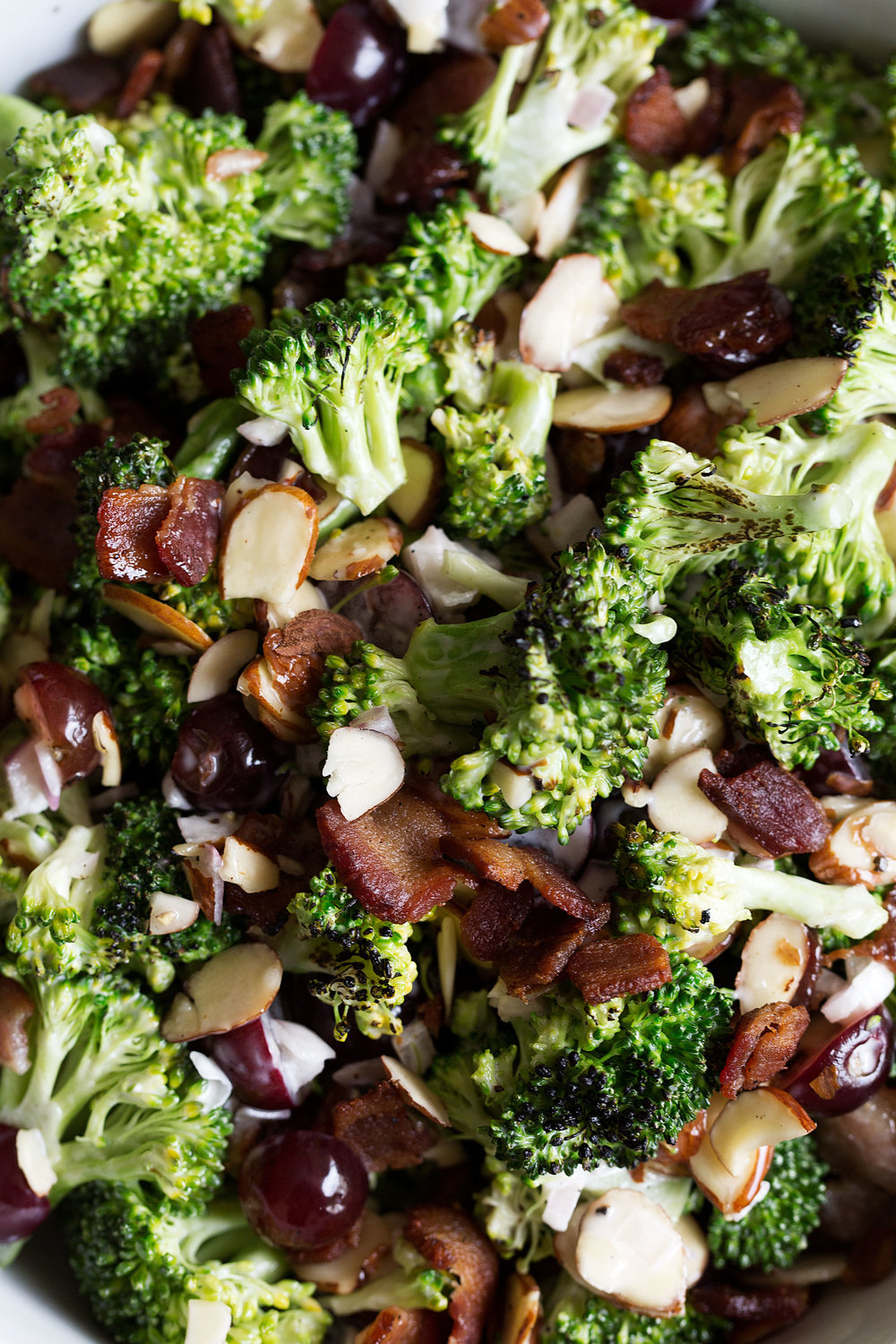 broccoli salad with grapes, bacon and almonds closeup shot
