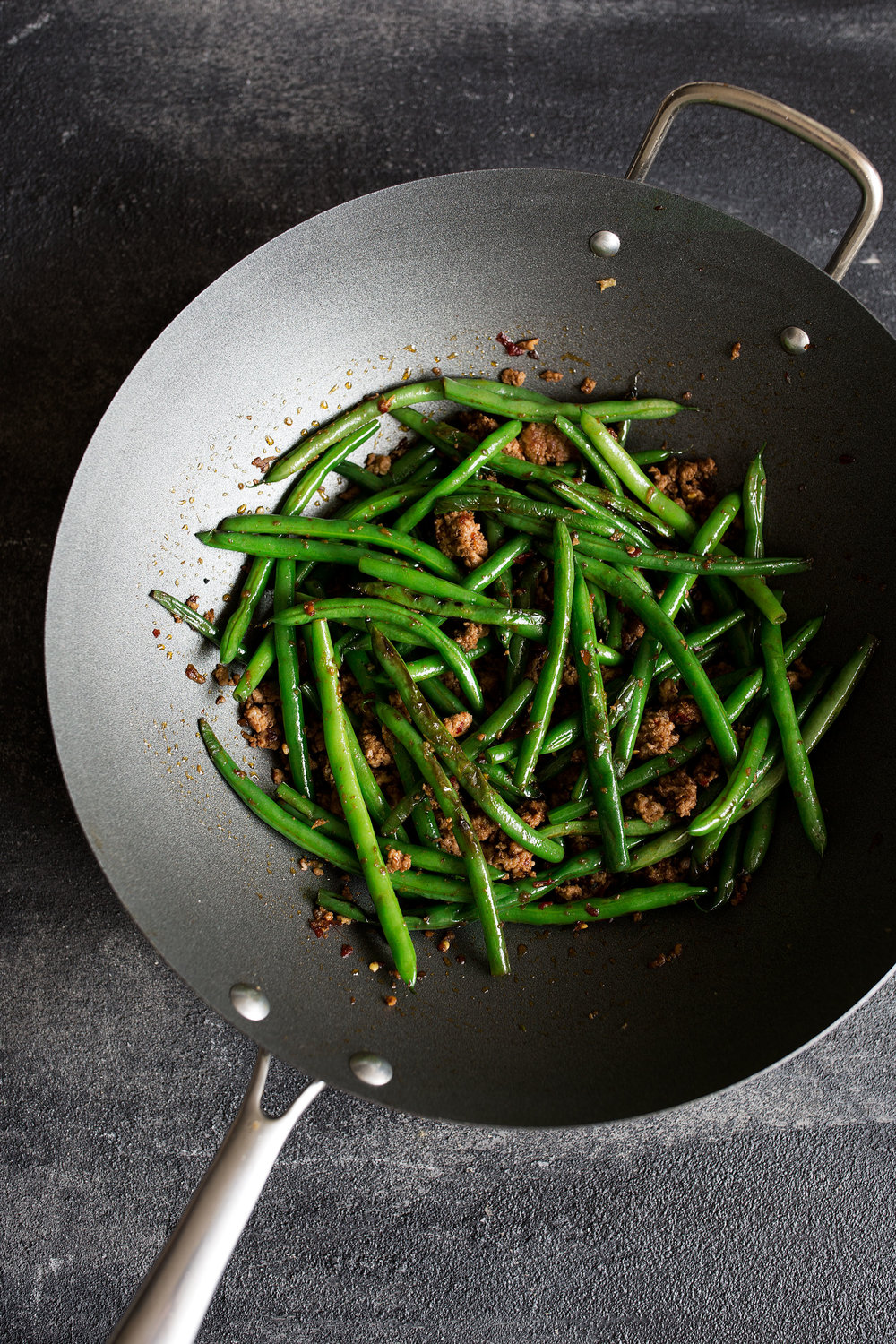 sautéed green beans in pan with ground pork