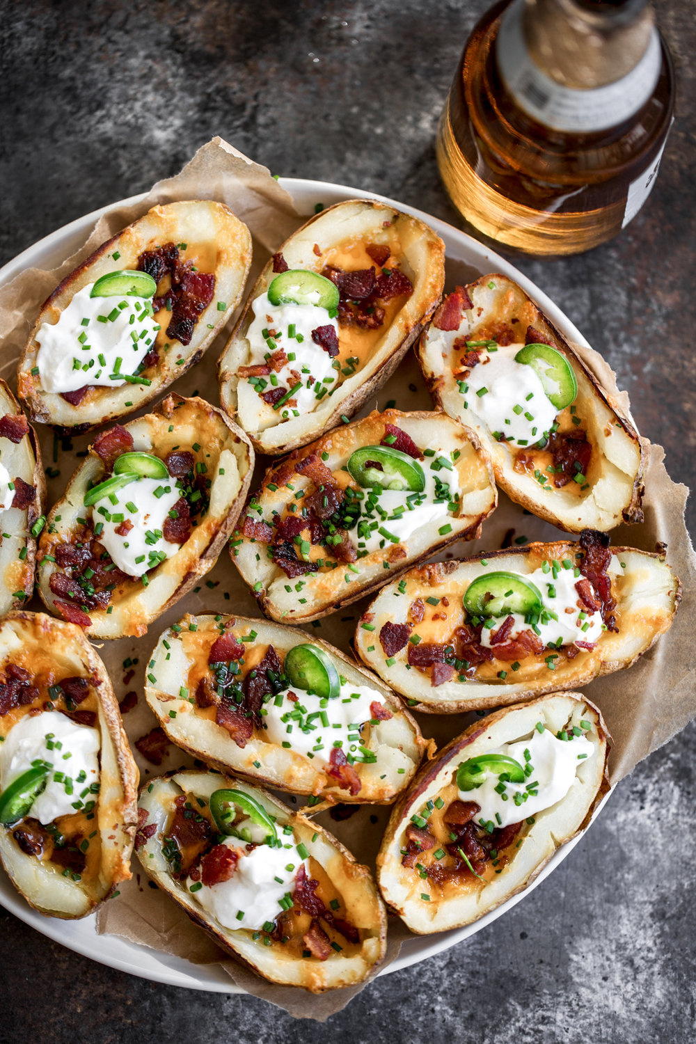 cheesy game day potato skins with cheddar, bacon sour cream jalapeños and chives