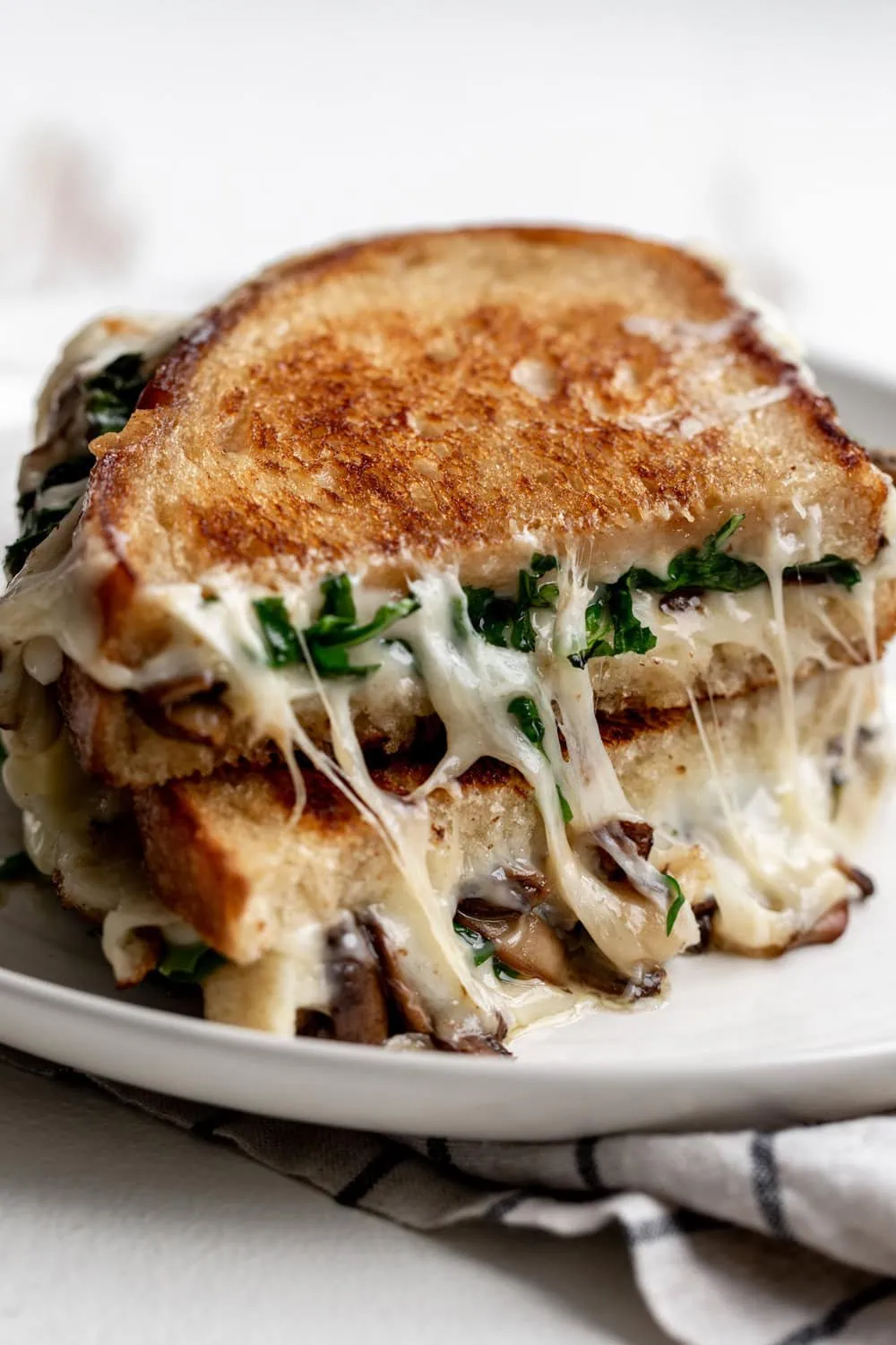 truffle grilled cheese stacked with mushrooms and arugula