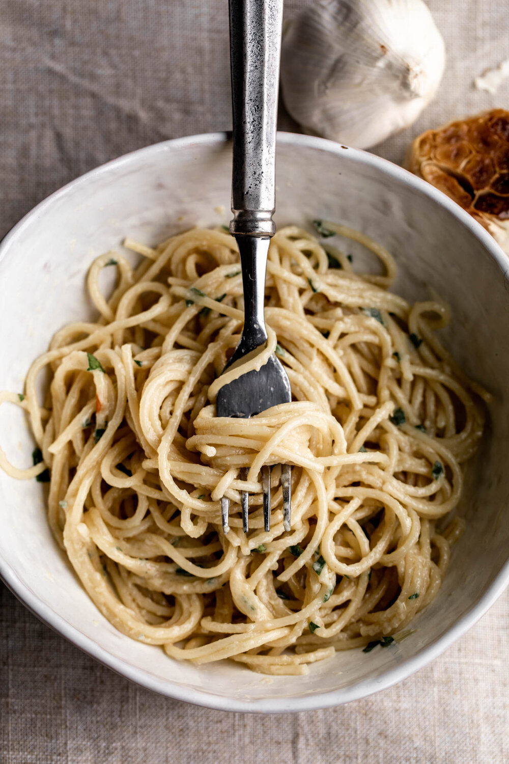 simple roasted garlic spaghetti pasta twirled around fork