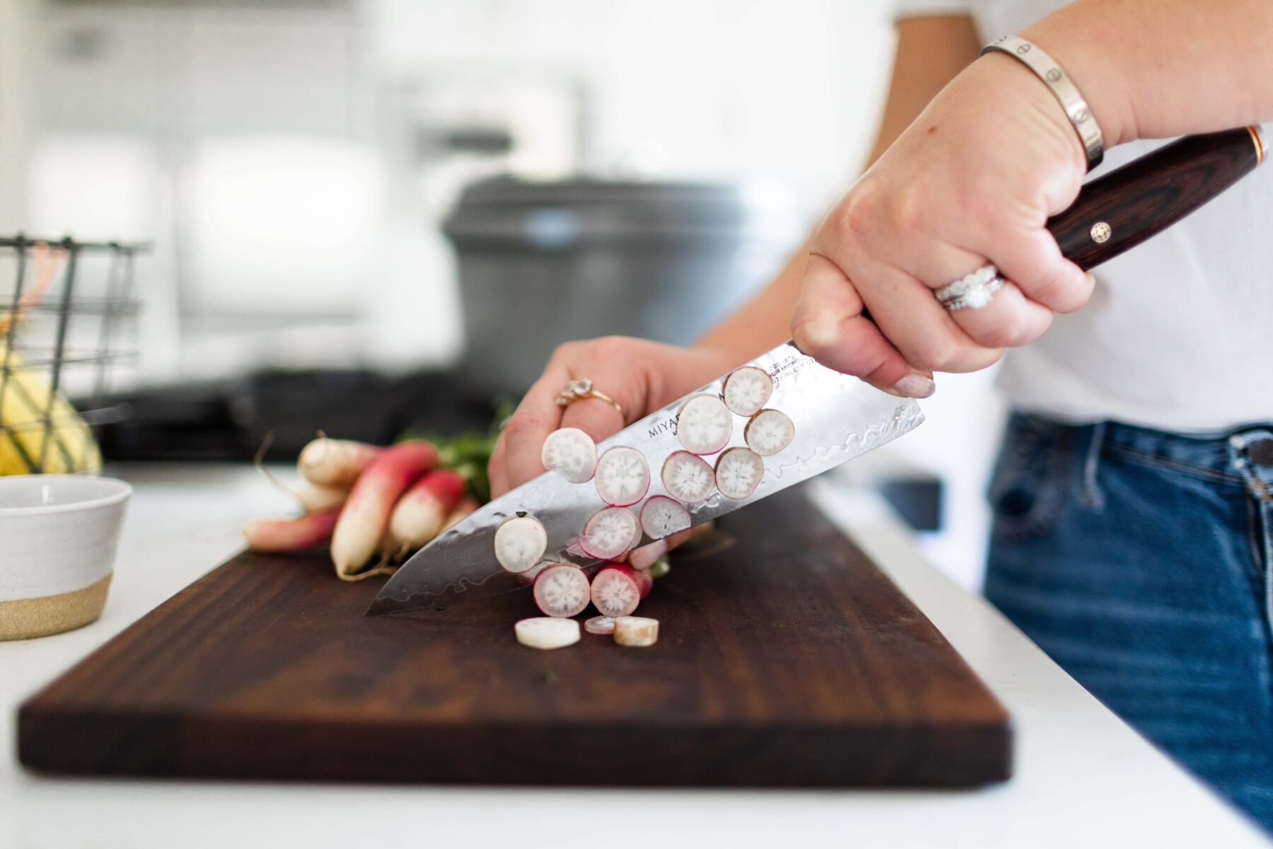 thinly sliced radish on cutting board.