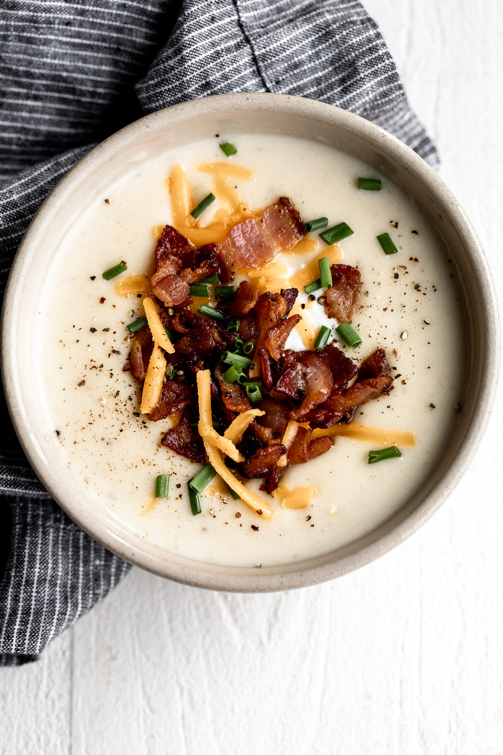 creamy baked potato soup topped with cheddar cheese chives and sour cream
