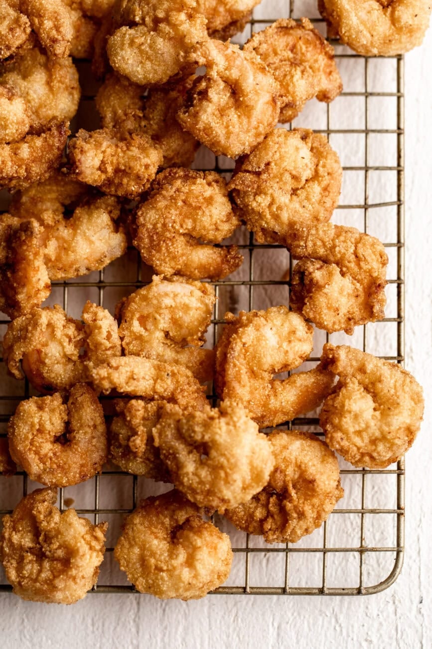fried crispy shrimp on wire rack.