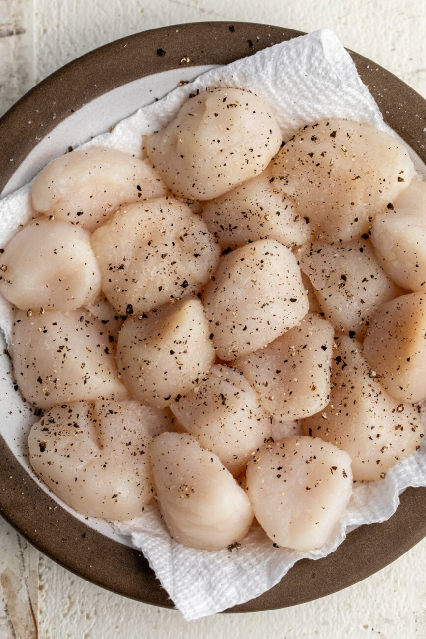 prepped scallops with salt and pepper.