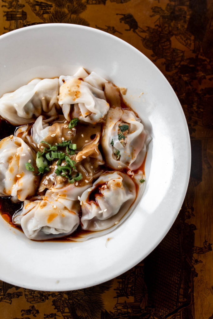 deluxe green bo wontons in peanut sauce with chili oil