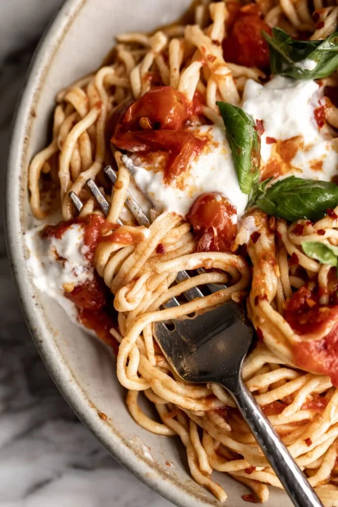 twisted fork with spaghetti and confit tomatoes