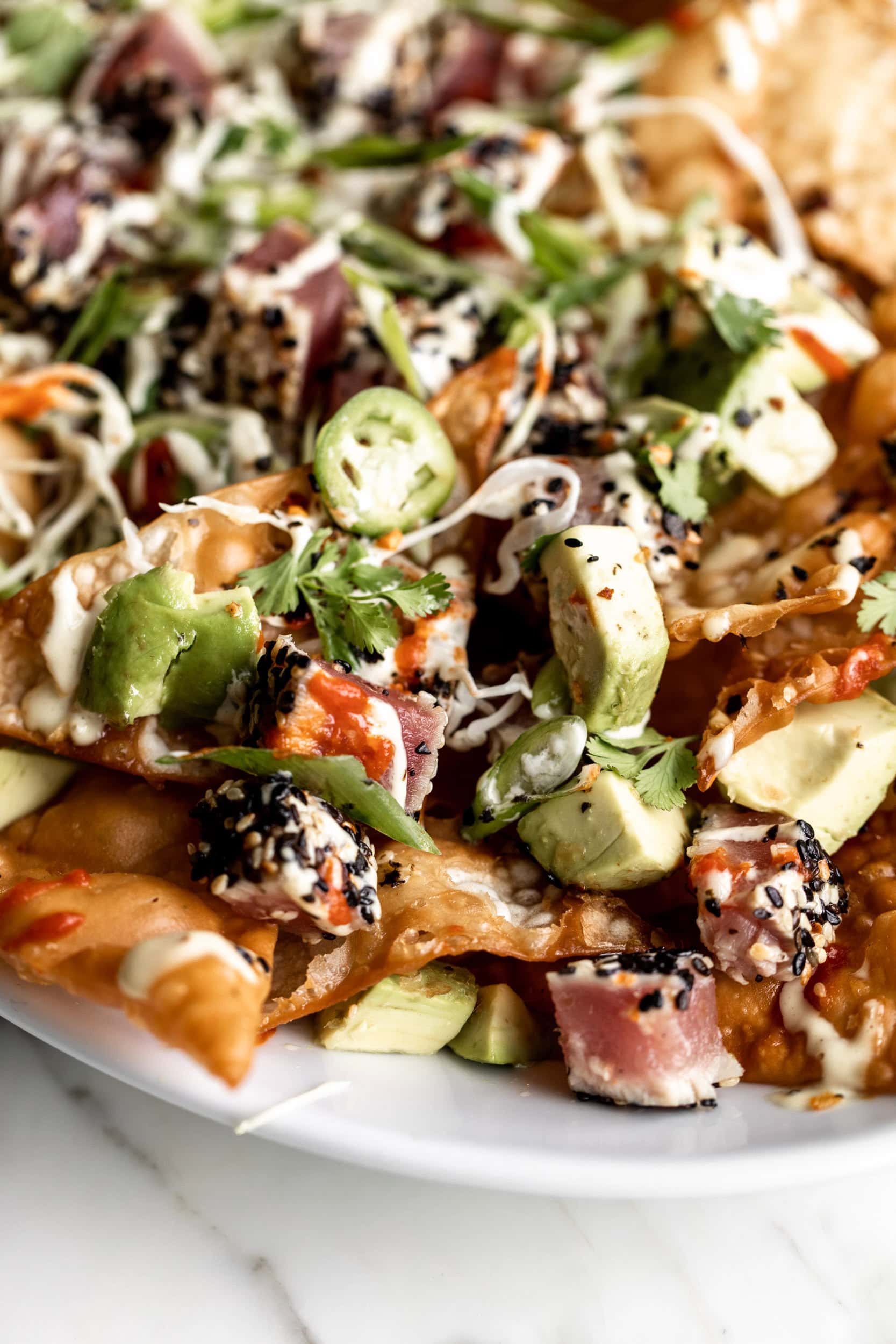 fried wonton nachos with ahi tuna and avocado.