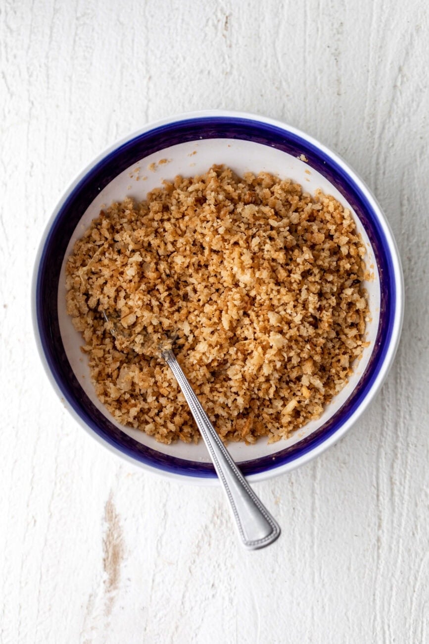buttered breadcrumbs in a small blue rimmed serving bowl.