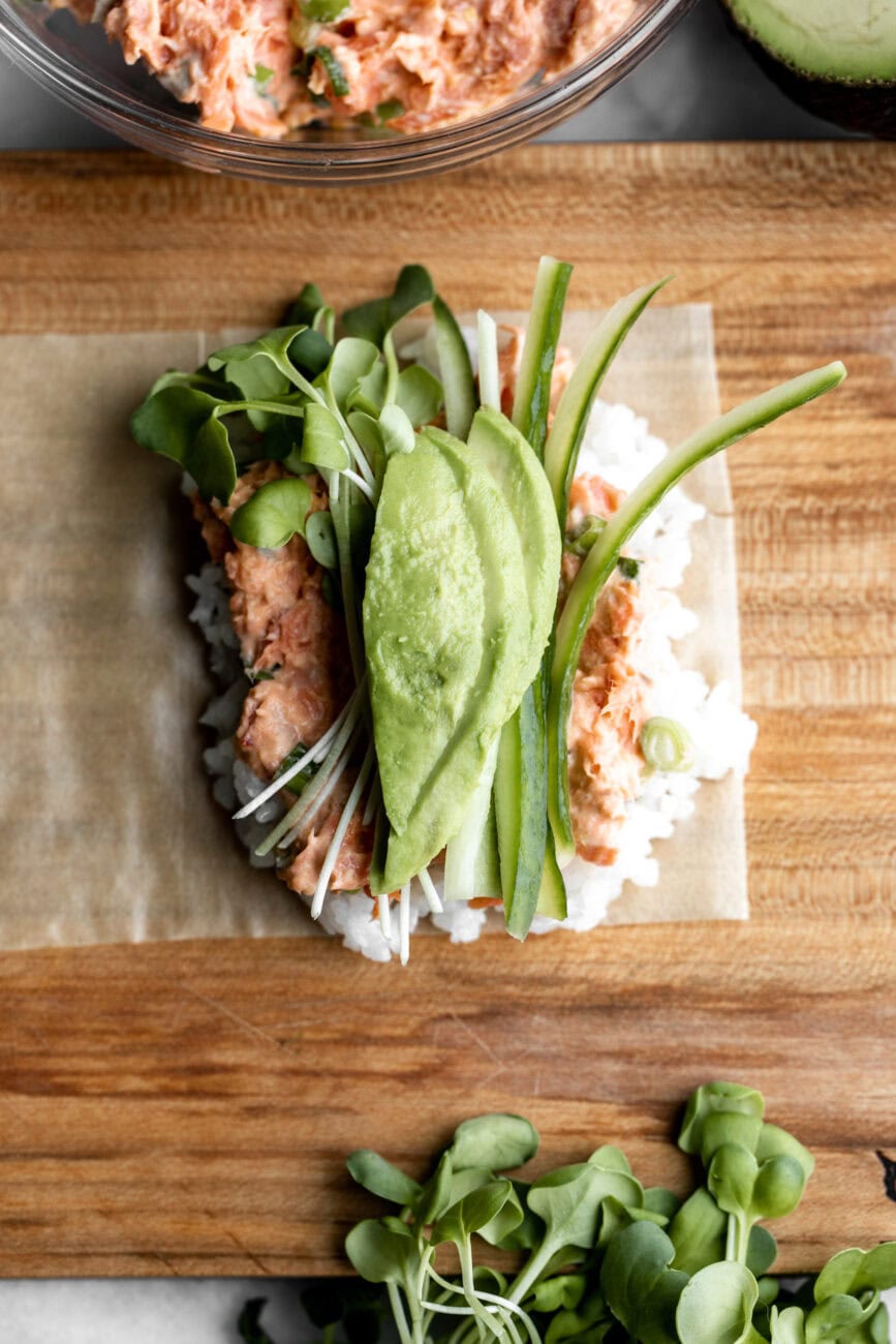 baked salmon hand rolls with avocado cucumber on soy paper.