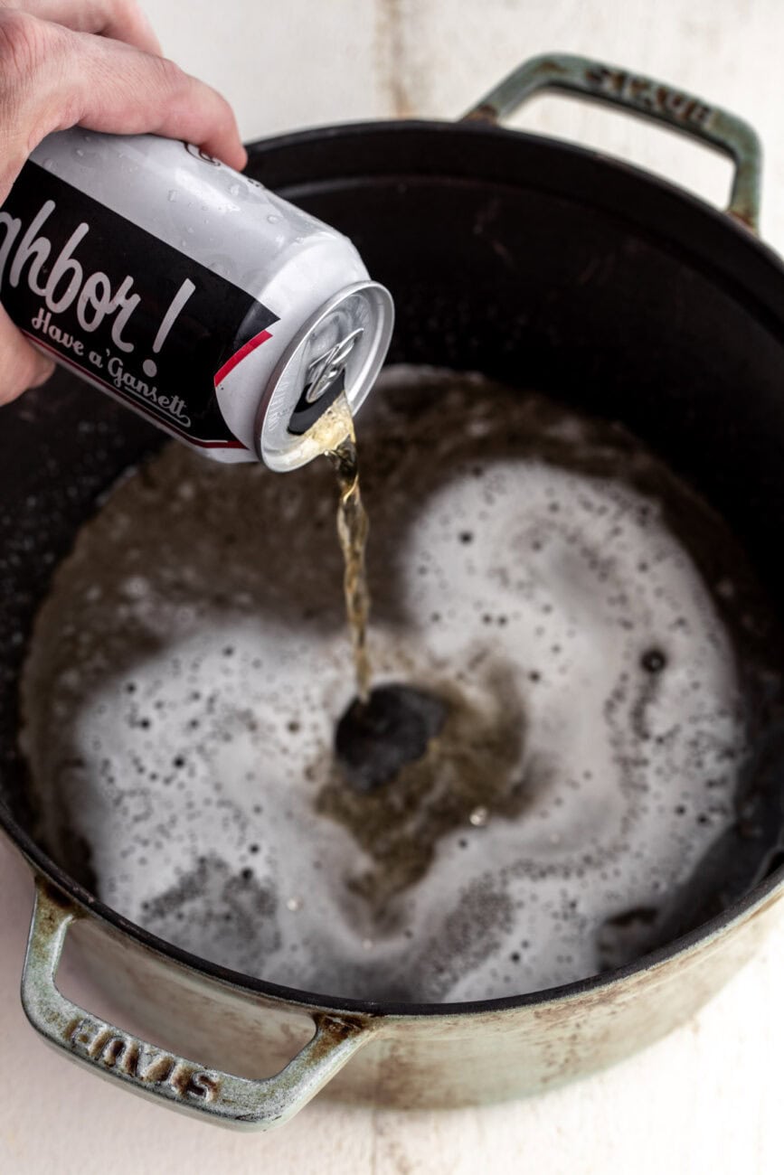pouring lager beer into a pot to boil.