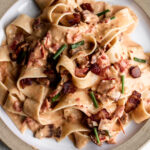 easy tomato and bacon pasta recipe on ceramic plate