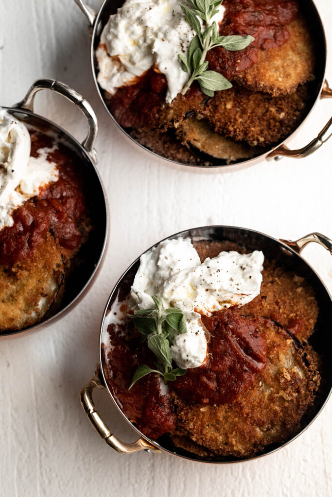 eggplant parmesan topped with burrata and marinara in small dishes