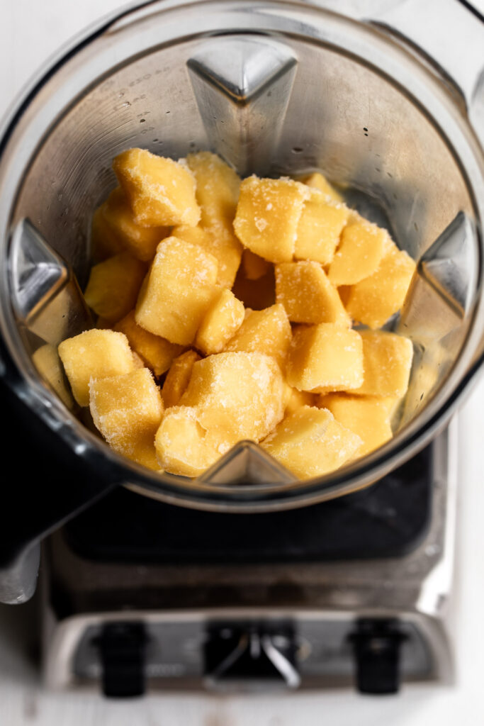 Mango chunks and tequila in blender