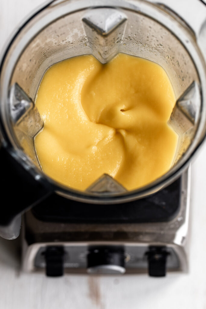 frozen mango margarita cocktail in blender closeup