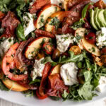 crispy prosciutto with peaches, tomatoes, mozzarella and arugula with basil vinaigrette