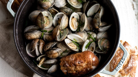 beer steamed clams in large staub with bread