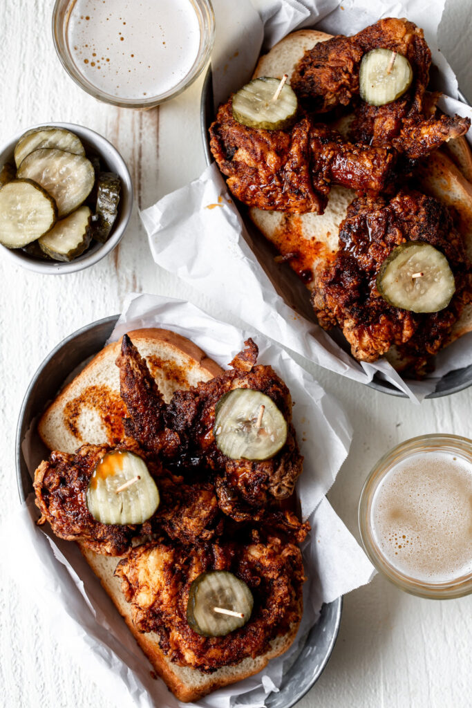 fried nashville-style hot chicken in grey boats with pickled and a side of beer