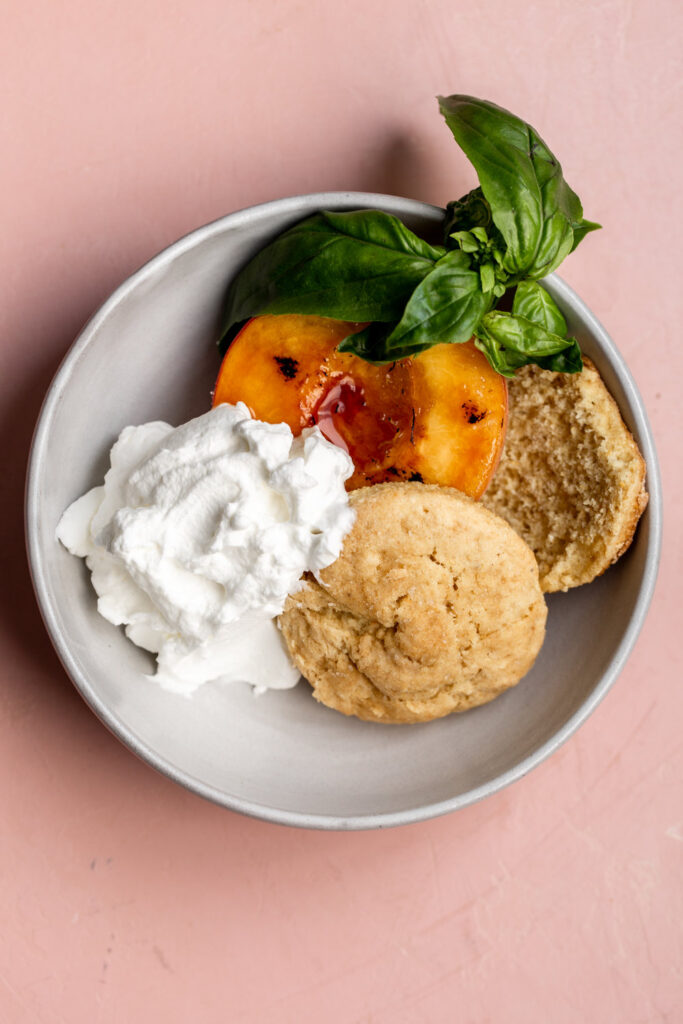 Brulée Peaches with Cornmeal Buttermilk Biscuits and Whipped Cream