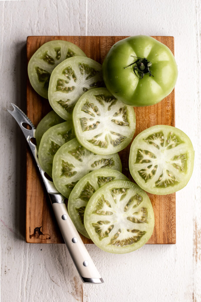 sliced green tomatoes on cutting board