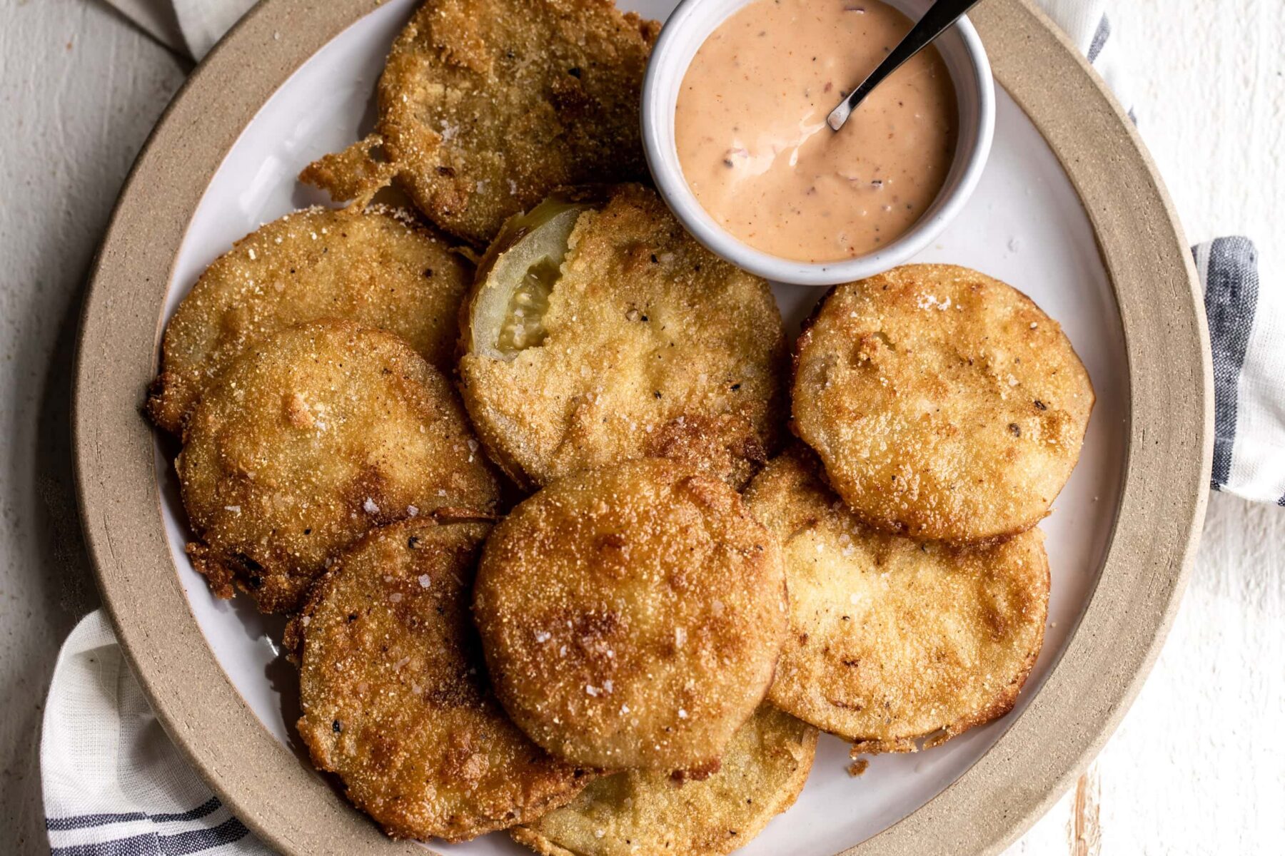 fried green tomatoes in flour and cornmeal batter paired with Mississippi comeback sauce.