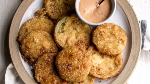 In fried green tomatoes Slices of green tomato are tossed in buttermilk and fried in a flour and cornmeal batter to crunchy golden-brown perfection and then paired with Mississippi comeback sauce