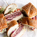 This Italian sub sandwich or hoagie is made with salami, prosciutto, mortadella, ham and capicola with provolone cheese on rolls.