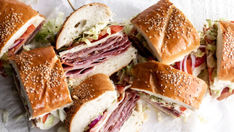 This Italian sub sandwich or hoagie is made with salami, prosciutto, mortadella, ham and capicola with provolone cheese on rolls.