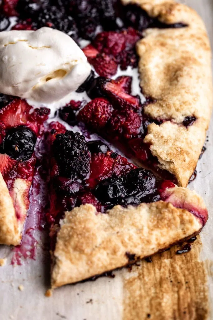 mixed berry galette with raspberries strawberries blueberries and blackberries in pastry dough closeup