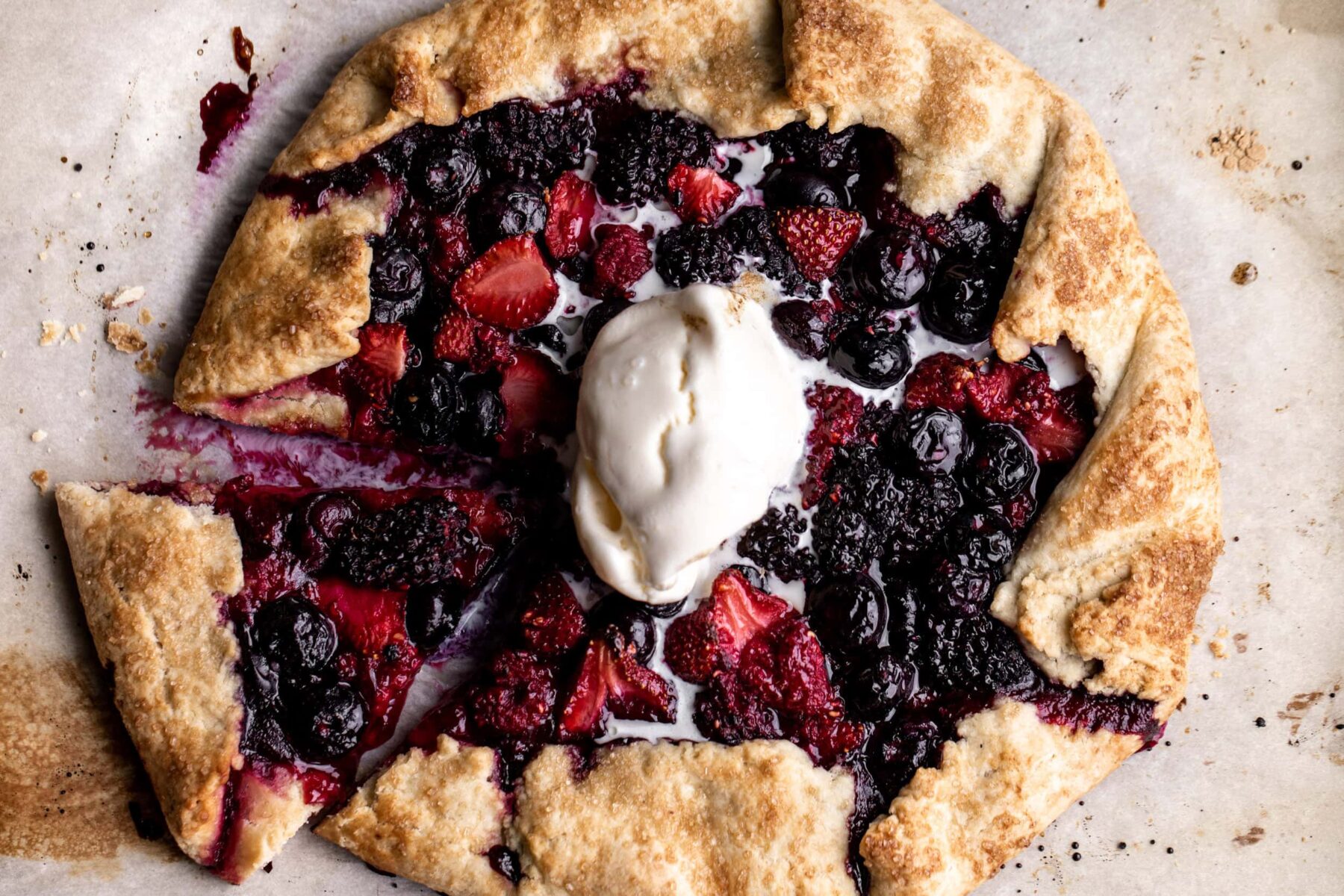 mixed berry galette with raspberries strawberries blueberries and blackberries in pastry dough.