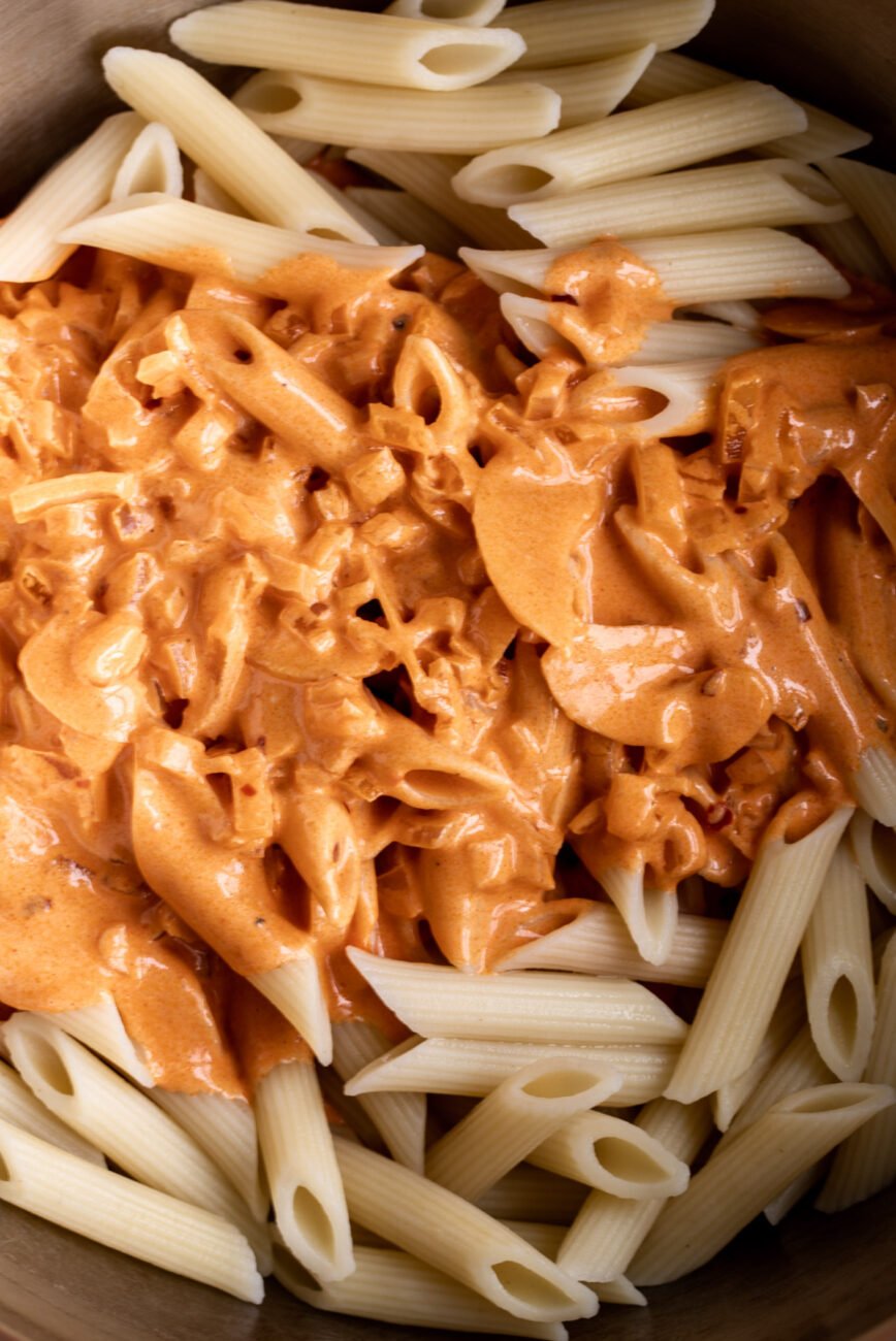 Penne pasta served in creamy tomato vodka sauce.