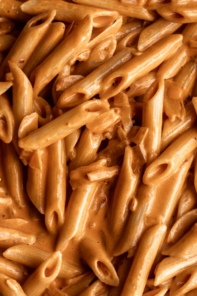 closeup penne alla vodka tomato cream sauce from cooking with cocktail rings