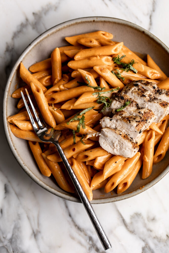 penne alla vodka with chopped basil and grilled chicken breast