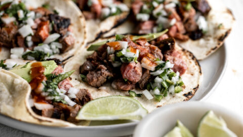 adobada tri-tip sliced served as tacos with avocado, onion and cilantro