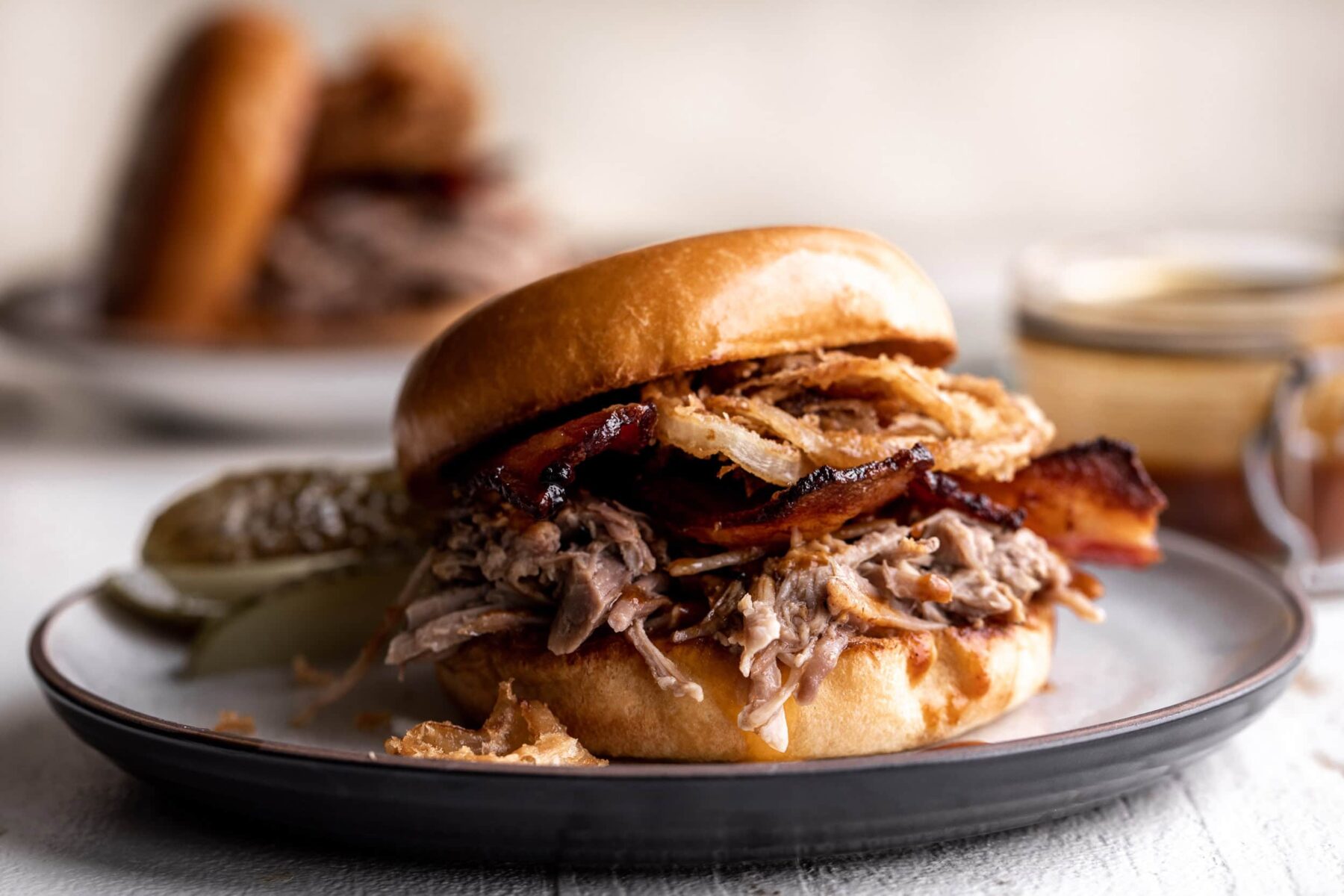 braised pulled pork sandwich with bacon.